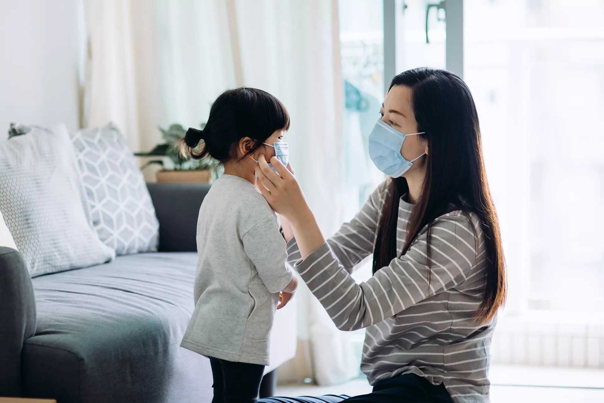 Mom helping son put on covid mask