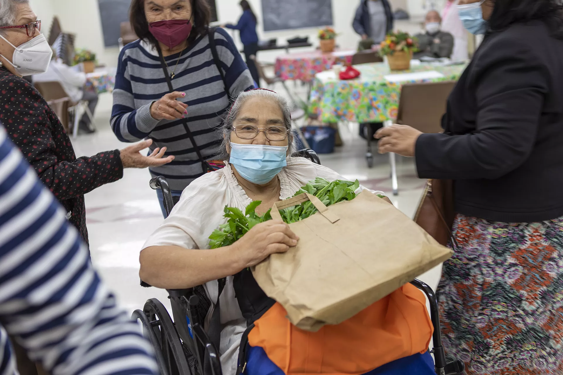 Woman in wheelchair getting food from food bank