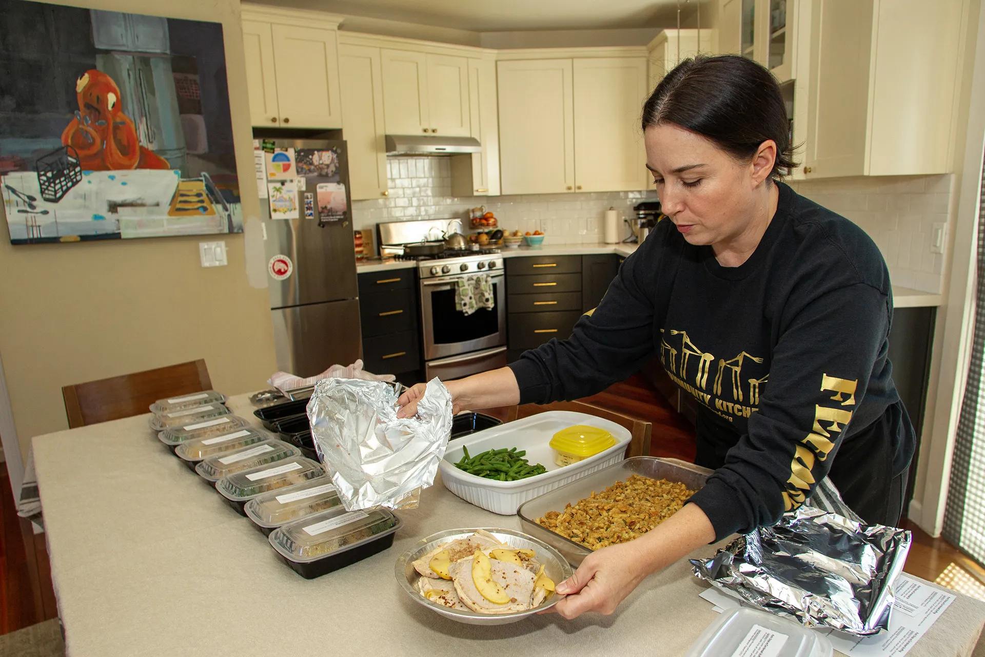Woman preparing meals in community kitchen