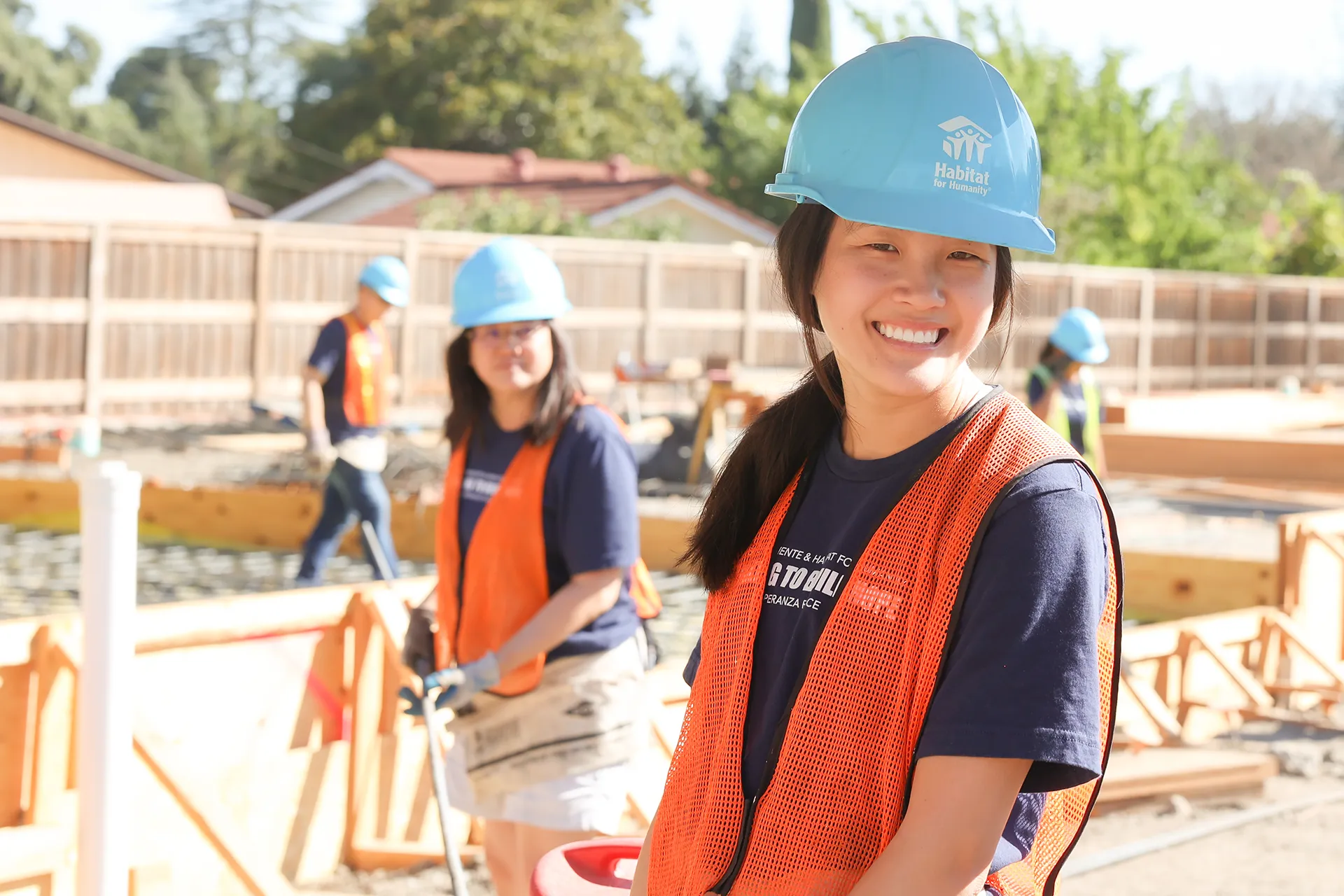 Volunteers smiling on construction site