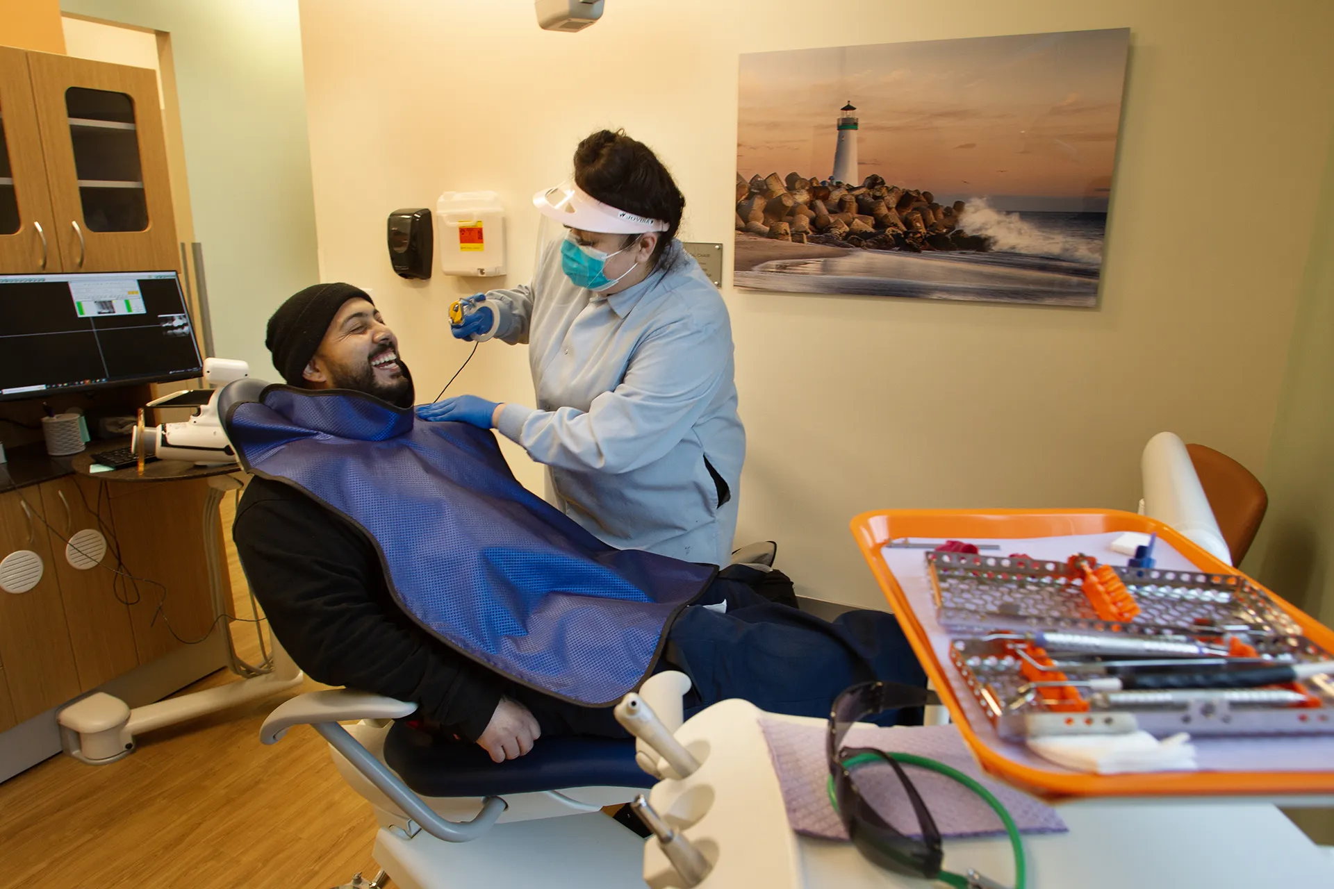 Dentist cleaning patients teeth