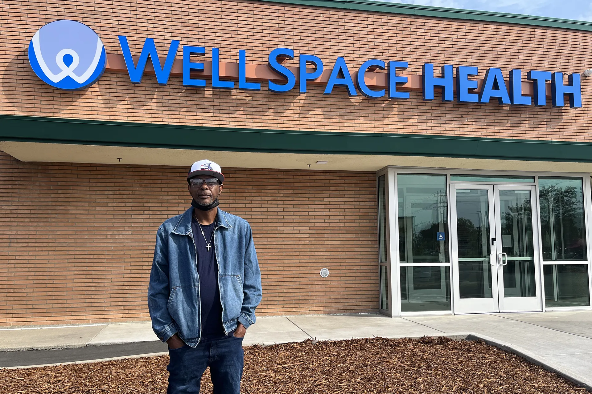 Man standing in front of Wellspace Health building